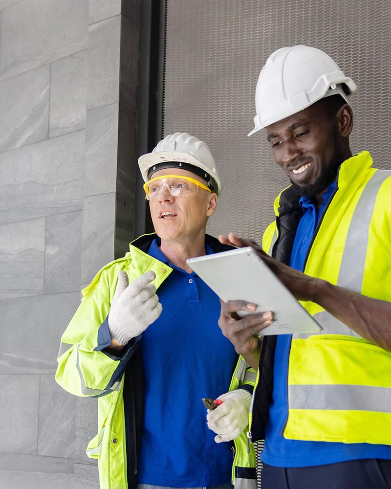 Two Industry Engineers Use Digital Tablet to Discuss about Their